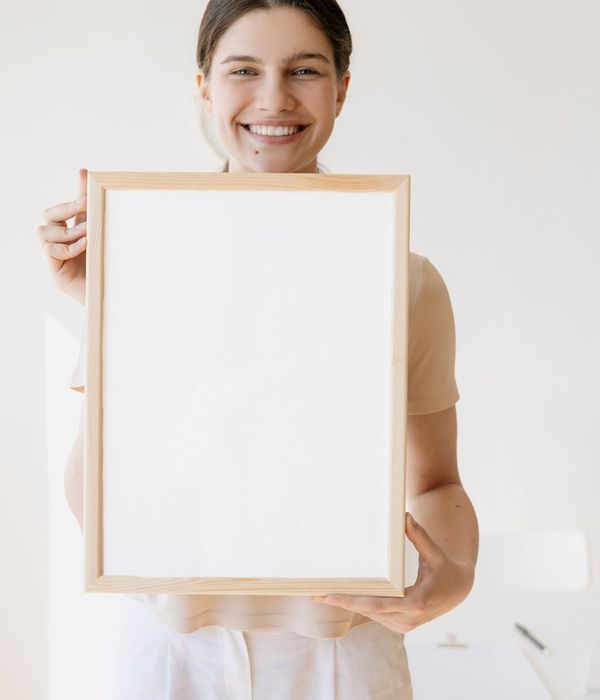 Woman feeling energized and happy in a bright, open space.